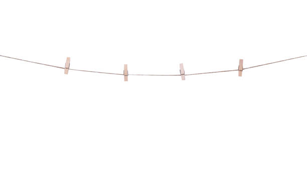 istock Four wood clothes pegs patterns hanging on brown string isolated on white background , clipping path 1419752467