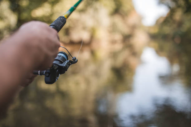 istock Unrecognizable fisherman angling on the river during sunny day 1419753101