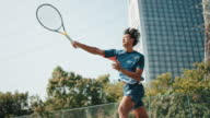 istock Asian Chinese Professional Male Tennis player jumping smash in tennis court during competition round 1419763086