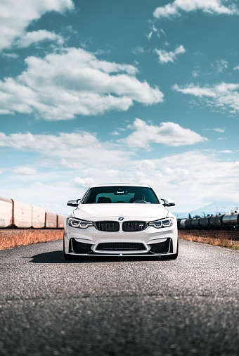 Seattle, WA, USA\nAugust 5, 2022\nWhite BMW M4 parked on asphalt with a train in the background