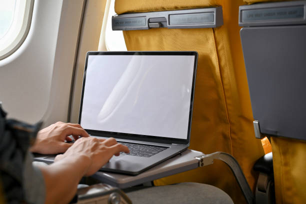 istock A male passenger in economy class using his portable laptop during the flight. close-up image 1419766066