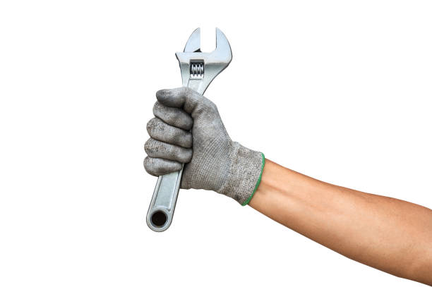 istock A wrench being held by a hand with a leather work glove on. 1419767225