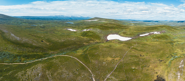 Aerial view overlooking a trail that leads up to the mountain of Kariknallarna in Harjedalen, Sweden. Seen at day in the summer.