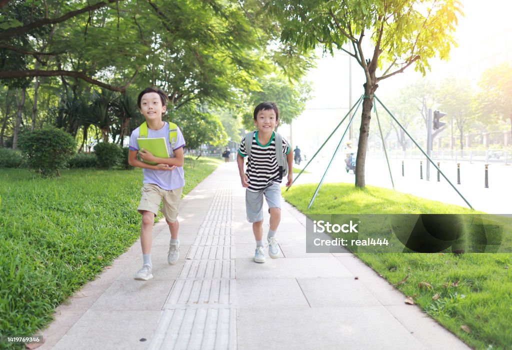 Elementary school boy running to school Boy carrying a school bag 10-11 Years Stock Photo