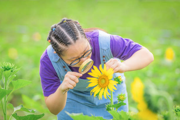 istock young girl with down syndrome exploring sunflower with magnifying glass 1419769993