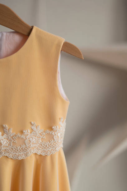 istock Yellow dress hanging on a hanger 1419774034