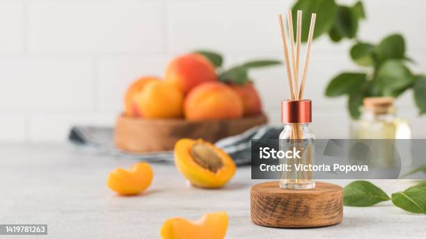 Interior Perfume With The Scent Of Apricots Jar With Aroma Oil And Banbu Sticks Stock Photo - Download Image Now