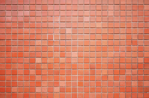 Antique mosaic tile texture for background. Red gradient square tile wall backdrop