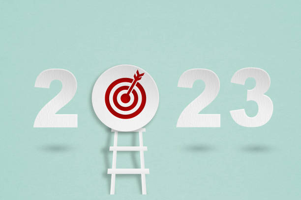 2023 year with red target dartboard paper cut and ladder for setup business target concept stock photo