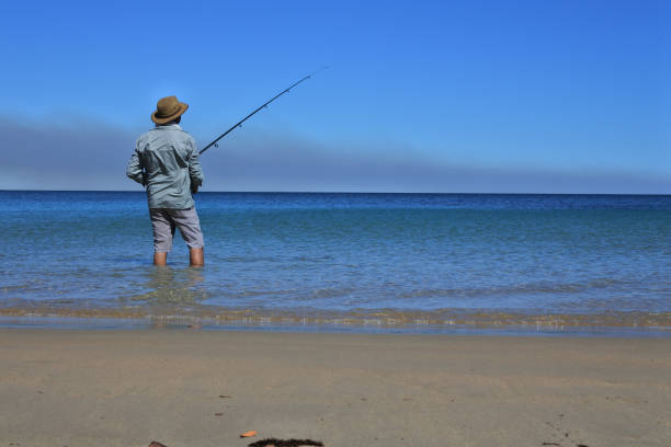 Man holding a fishing rod at sea