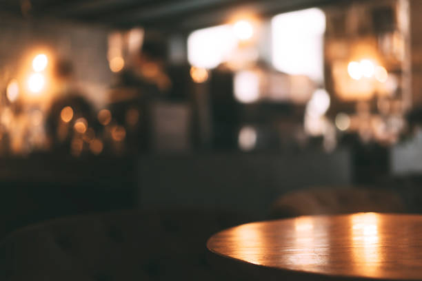 Mahogany wood table surface in warm luxury style cafe. Blur bokeh background with copy space for place display product.
