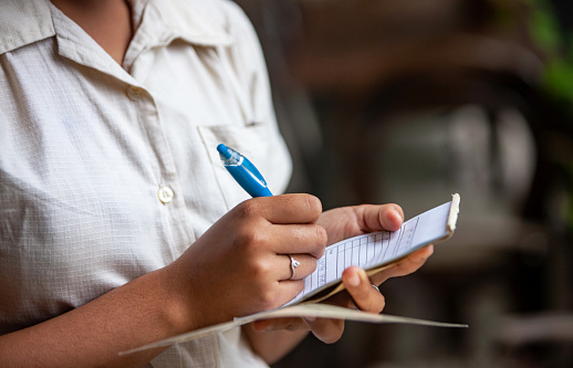 Close up of waitress taking the order, taking down order