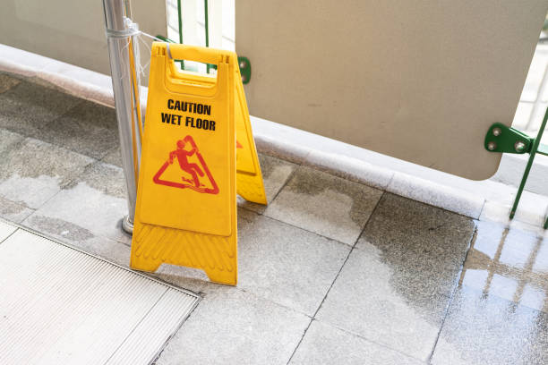 istock Yellow Caution slippery wet floor sign on the wet ground 1419789520