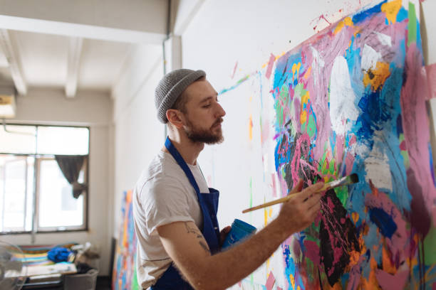 istock Artist Working On His Painting In Natural Light Art Studio 1419791033