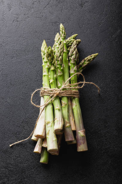 istock Green asparagus on a black background 1419796225