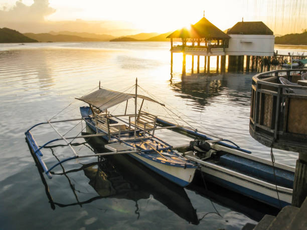 Scenic view of boat moored at port during sunset, Coron Island, Coron, Philippines.