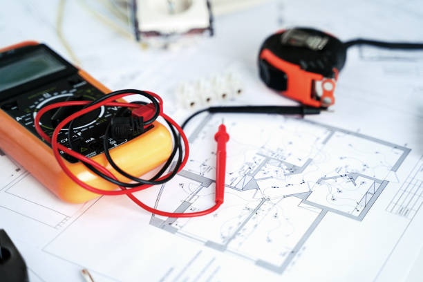 istock Making repairs,planning electricity project in house.Drawings,diagrams,plan for electrification of apartment, building. Devices and accessories, voltmeter, wires, screwdriver, pliers and tape measure 1419797788