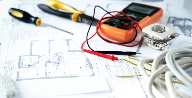 istock Making repairs,planning electricity project in house.Drawings,diagrams,plan for electrification of apartment, building. Devices and accessories, voltmeter, wires, screwdriver, pliers and tape measure 1419797793