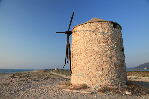 View of old windmill at Gyra beach at Lefkada Island, Greece.
