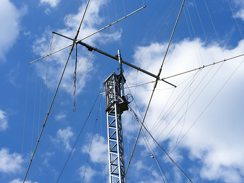 A close-up shot of a ham radio antenna against a cloudy sky