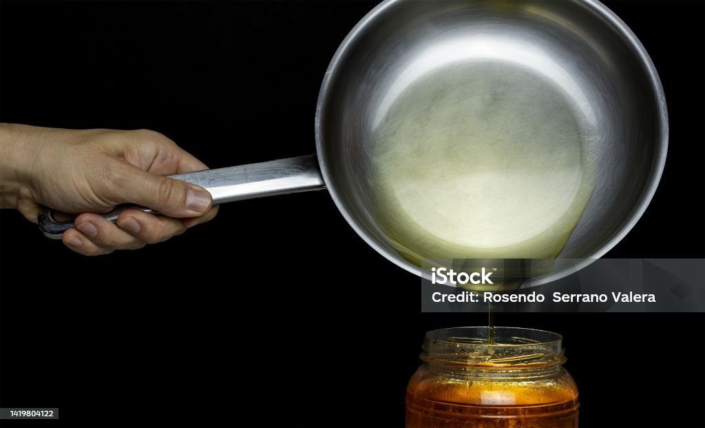 Recycling homemade oil from a frying pan Cooking Oil Stock Photo