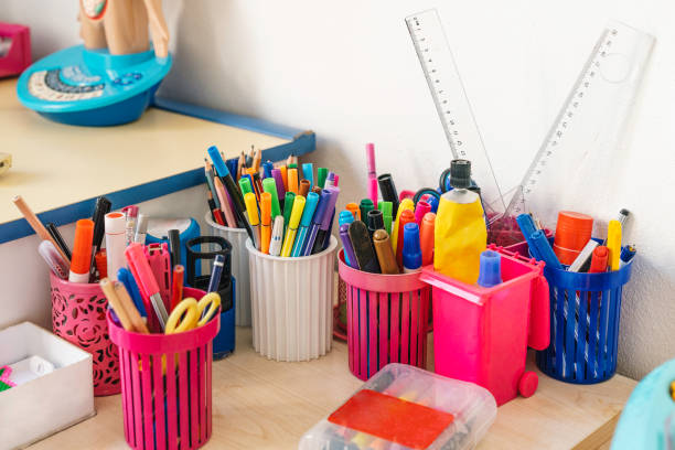 Pens and pencils on the school\n desk