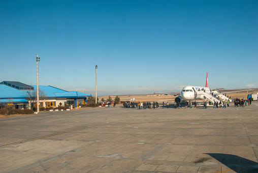 Kars, Turkey - December 25, 2006 : Passengers of the Turkish Airlines flight, which makes the Istanbul-Kars flight, are walking to the exit terminal.