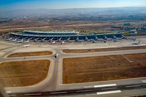 Ankara, Turkey - November 3, 2016 : Aerial shot of Esenboğa Airport in Ankara. An airplane is seen on the ground preparing to take off.