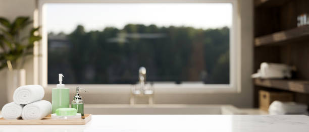 istock Bath accessories and copy space on modern marble white tabletop over blurred bathroom in background 1419809006