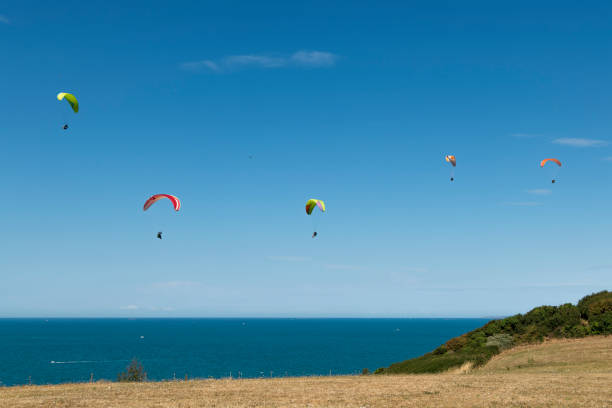 istock The Atlantic coastline with several paraglider pilots sustaining themselves while paragliding. 1419809849