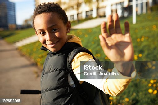 istock Portrait of happy school boy smiling schoolboy little boy child with backpack alone going running to children kid at sun street outdoors, First-grade student primary first class education 4 K slow-mo 1419812265