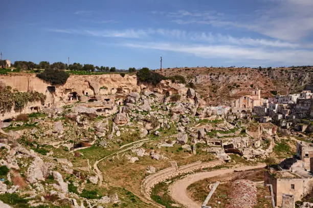 Ginosa, Taranto, Puglia, Italy: landscape of the old town with the ancient church and the cave houses carved into the rock in the village near Matera