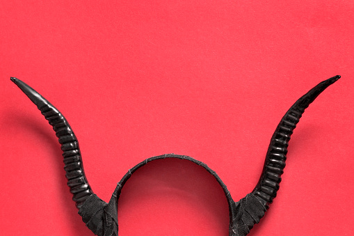 Black horns hair band on red background