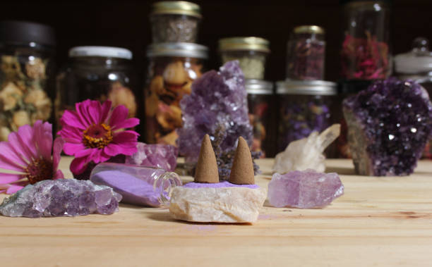 istock Amethyst Crystals With Flowers and Incense Cones on Meditation Table 1419814943