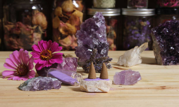 istock Amethyst Crystals With Flowers and Incense Cones on Meditation Table 1419814954