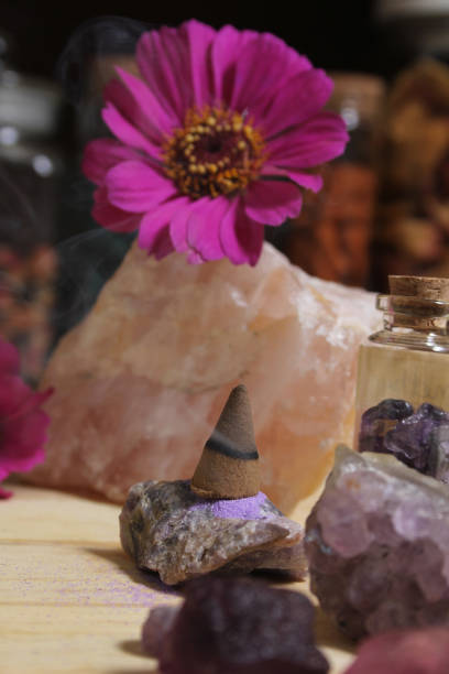 istock Amethyst Crystals With Flowers and Incense Cone on Meditation Table 1419814971