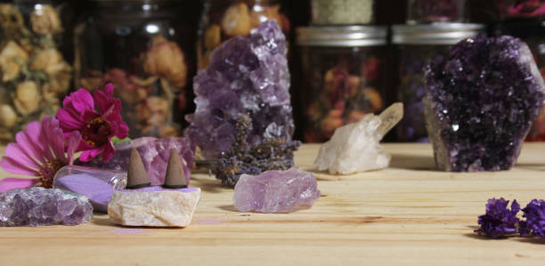 istock Amethyst Crystals With Flowers and Incense Cones on Meditation Table 1419814998