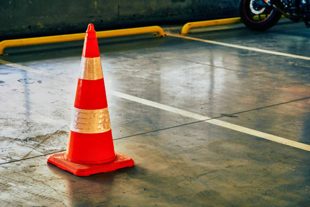 istock Reflective traffic safety cone in a closed parking lot 1419815422