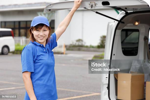 A Woman Opens The Door Of A Light Van And Finds Cardboard Boxes Piled Up Driver Of A Light Van Or Light Cargo Stock Photo - Download Image Now
