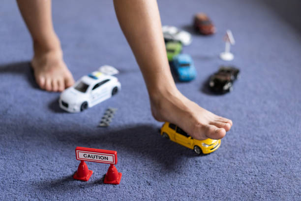 Stumbling on toy car at home Stumbling on toy car at home broken toy stock pictures, royalty-free photos & images