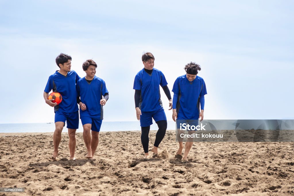 Young male soccer team practicing on the beach Young men beach soccer team.
Athlete practicing on the beach on holidays. 20-24 Years Stock Photo