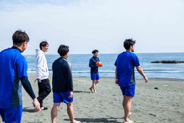 istock Soccer team walking on the beach 1419823165