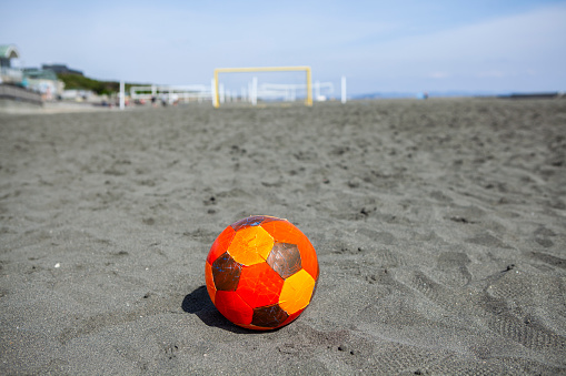 A beach soccer court set up on the beach by the sea.
beach soccer ball.