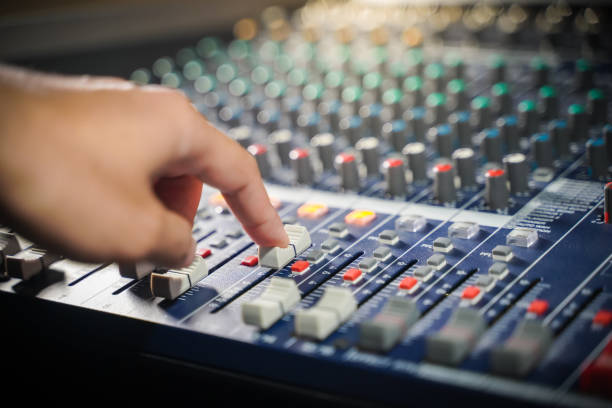 istock Men's hands are controlling the console of a large hi-fi system 1419825244
