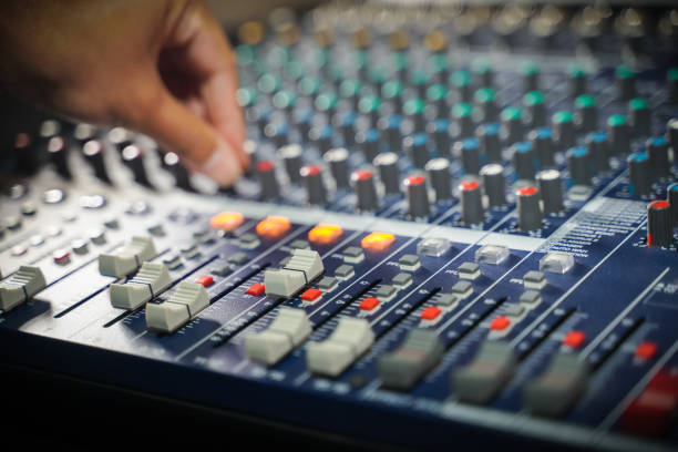 istock Men's hands are controlling the console of a large hi-fi system 1419825248