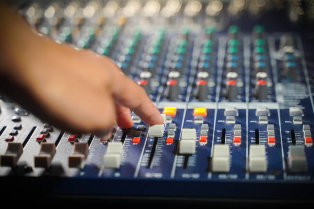 istock Men's hands are controlling the console of a large hi-fi system 1419825278