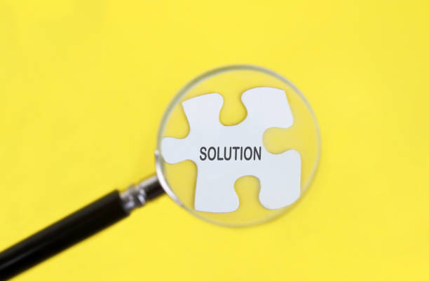 istock Looking at question mark puzzle with magnifying glass 1419825598