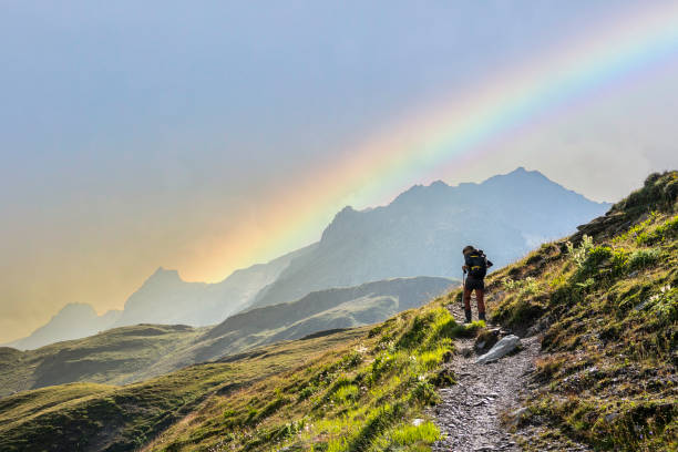 istock Lonely hiker on the mountain trail with rainbow 1419828178
