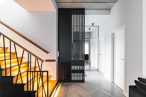 Modern wooden stairs and white walls, view from above