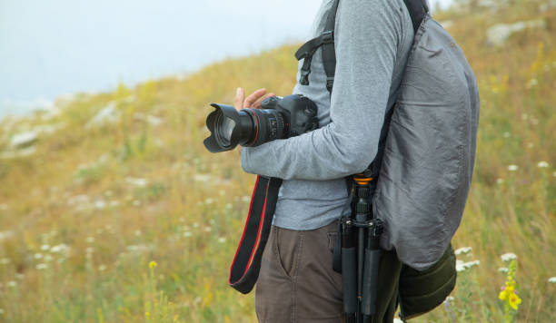 istock Photographer with backpack and digital camera in nature. Travel. Active lifestyle 1419832340